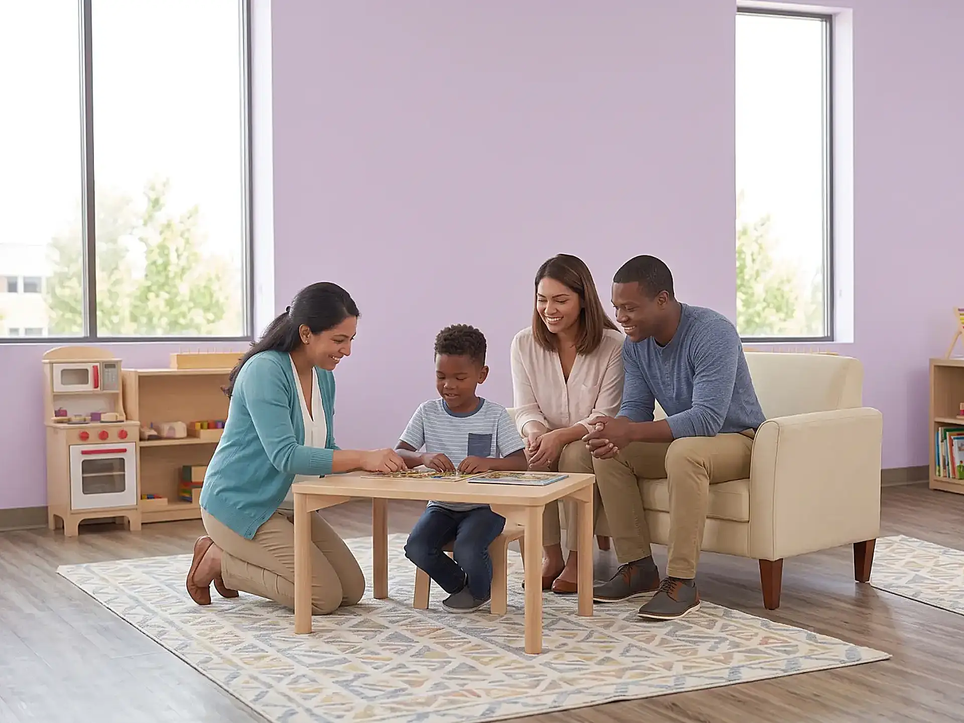 ABA therapist and family working together with a child with autism in a sensory-friendly therapy room at Children's Center, reflecting the family-centered approach to ASD treatment