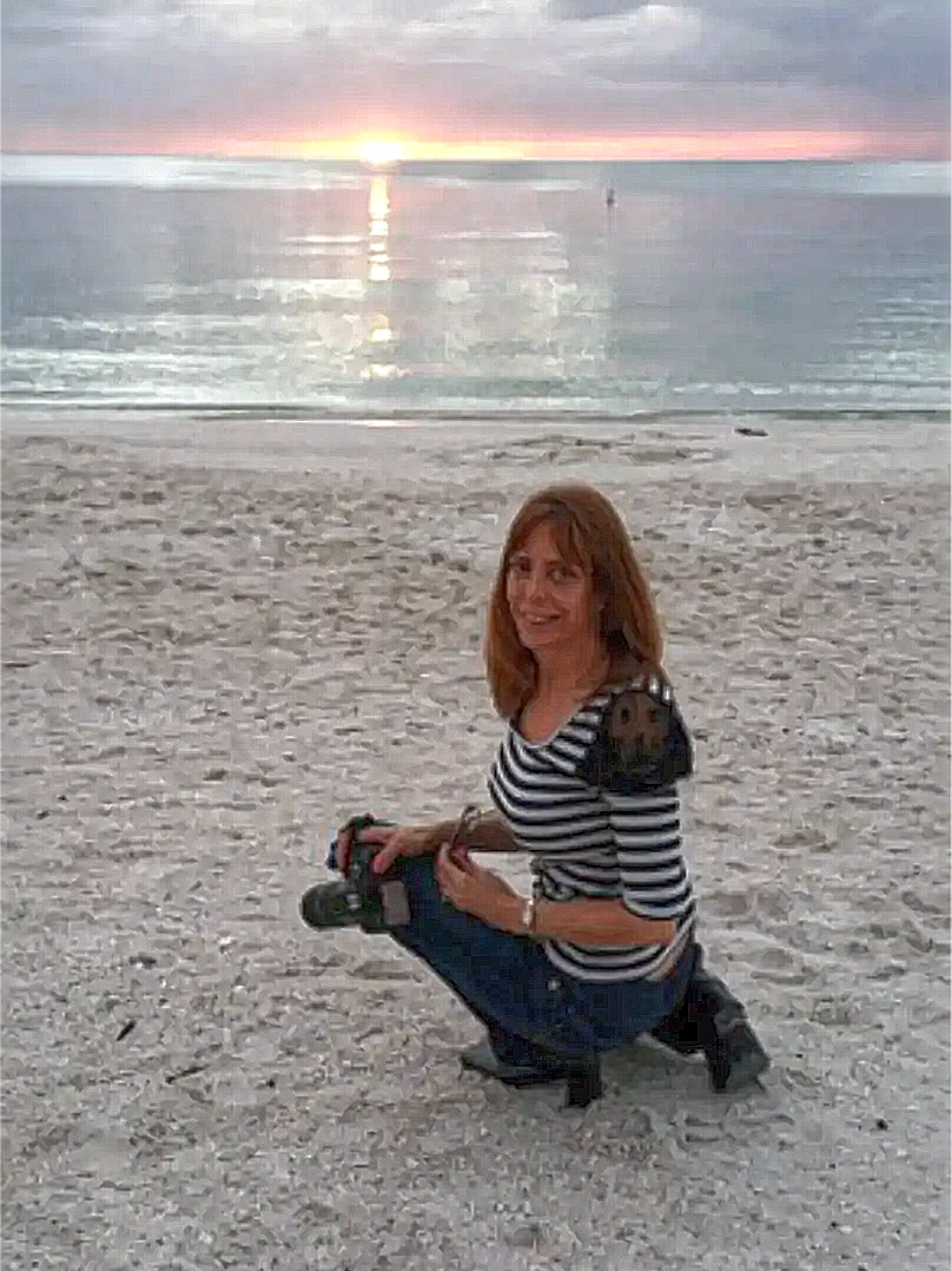 Shana Williams on the beach doing photography